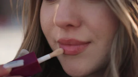 Outdoor shining lip application demonstration. Influencer style tutorial Stock Footage 346235250