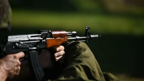 Outdoor shooting with automatic rifle in a shooting range Stock Footage 83583909