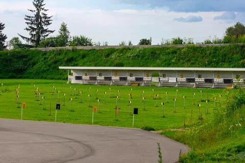 Outdoor Shooting Range With Numbered Targets On Grassy Field Stock Photos