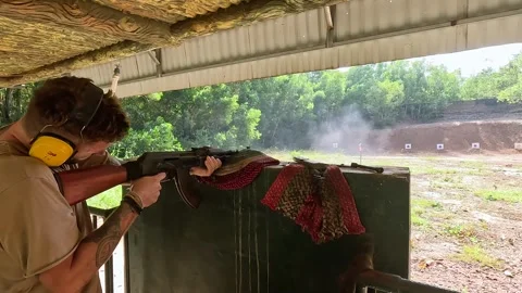 Outdoor Shooting Range - Young Man Shooting Stock Footage 240882078