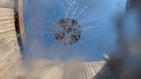 Outdoor shower from a low angle, spraying refreshing water from the shower head Stock Footage 342882665