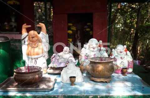Outdoor shrine with statues of the Laughing Buddha, Hong Kong Stock Photos