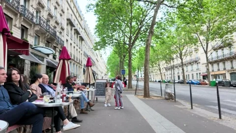 Outdoor Sidewalk Cafe Scene on a Tree Lined Paris Boulevard Stock Footage 335118541
