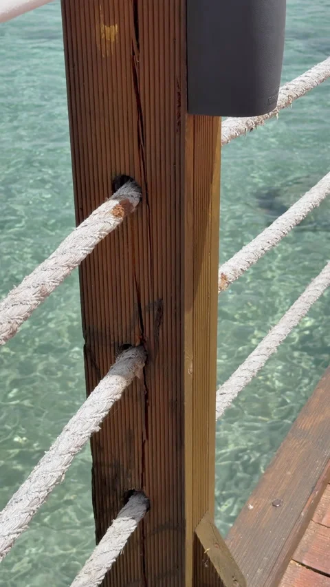 Outdoor speaker mounted on wooden post of a pier with turquoise sea background Vídeo Stock 346308367