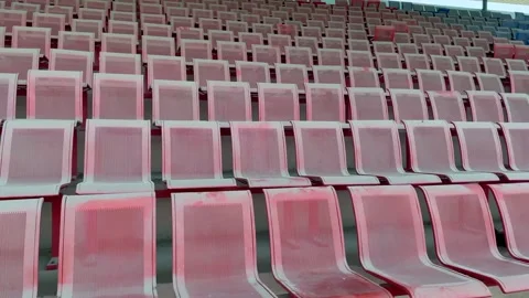 Outdoor stadium seating area with red and yellow chairs with stadium seats Stockbeeldmateriaal 332580146