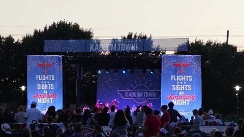 Outdoor stage performance with crowd watching at Kaboom Town event Stock Footage 340941177