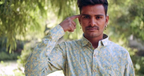 Outdoor static portrait of a person making hand sign gestures looking at camera Stock Footage 145448372