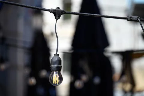 Outdoor string light bulb with bokeh background Stock Photos