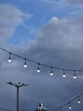 Outdoor string lights evening sky background Stock-Fotos