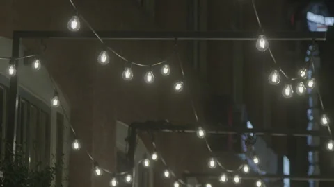 Outdoor String Lights Glowing in Night Urban Setting 스톡 동영상 343944671