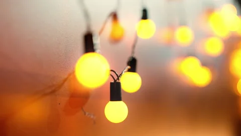 Outdoor string lights hanging on a line on outside house in backyard. Garde.. Stock Footage 253445922