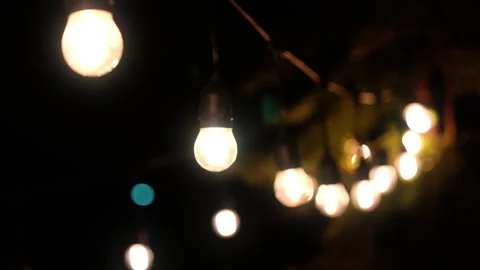 Outdoor string lights hanging on a line on outside house in backyard. Garde.. Stock Footage 253446005