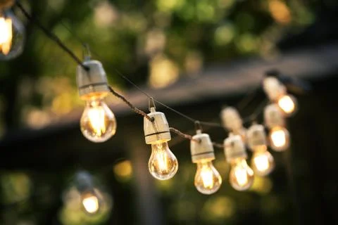 Outdoor string lights hanging on a line in backyard Stock Photos
