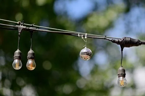 Outdoor string lights with small disco ball Stock Photos