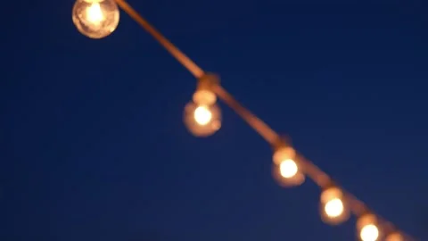 Outdoor string lights while pulling focus Video stock 154472925