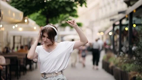 Outdoor summer lifestyle portrait of young pretty hipster woman in wireless Stock Footage 169474553
