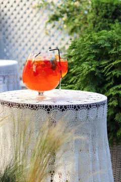 Outdoor table with refreshing summer drinks and decorative lace tablecloth Stock Photos