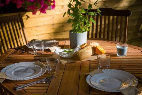 Outdoor Table Setting with Bread, Orange, and Mint Stock Photos