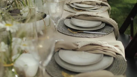 Outdoor table setting with elegant dining accents for a wedding or event. Close Stock Footage 310249164