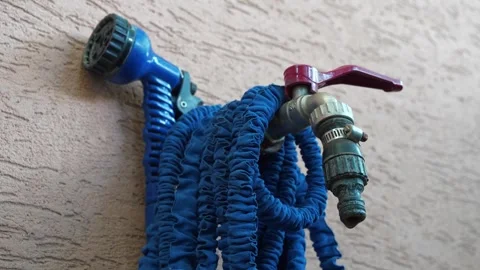 Outdoor tap for watering a garden plot. Water is dripping from the tap Stock Footage 315439414