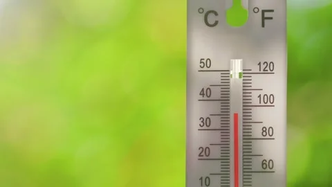 Outdoor thermometer showing rapid temperature rise on a hot summer day Stock Footage 313802190