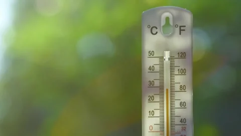 Outdoor thermometer showing rapid temperature rise on a hot summer day Stock Footage 313802192