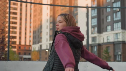 Outdoor Trainer Jogging Sideways Around Urban Sports Court Wearing Hoodie Vest Vídeo Stock 316646907