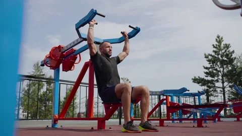 Outdoor training. A man does an exercise on his hands. Stock Footage 135203153