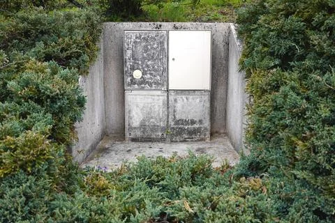 Outdoor utility electrical box installation surrounded by green bushes and .. Stock Photos