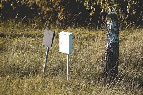 Outdoor view of an old mailbox post in a field Fotos de archivo