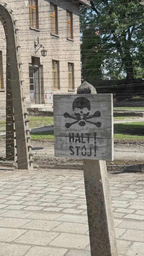 Outdoor view of original barbed wire fencing and a historical Halt danger sign Stock Footage 344467900