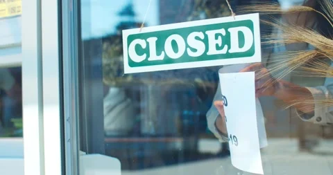 Outdoor view of window of florist store closed due to covid-19. Young female Stock Footage 138700838