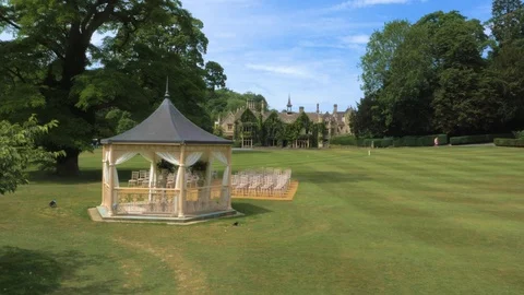 Outdoor wedding ceremony set up in front of stately home, drone aerial 4K Stock Footage 101138772