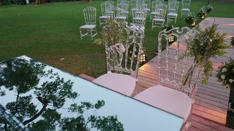 Outdoor wedding ceremony setup with decorated aisle, floral arrangements and Stock Footage 332620915