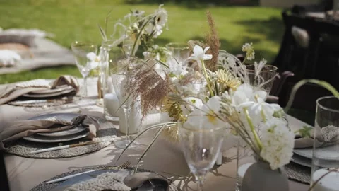 Outdoor wedding decor. Elegantly decorated outdoor dining table decorated with Stock Footage 308450689