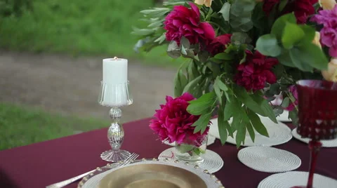 Outdoor Wedding table decorations with lighted candles, close-up Steadicam Stock Footage 50978600