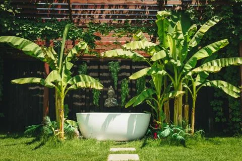 Outdoor white stone empty bath over green tropical nature background. Spa rel Stock Photos