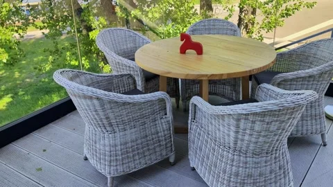 Outdoor wicker dining set on balcony with wooden table Stock Footage 336743329