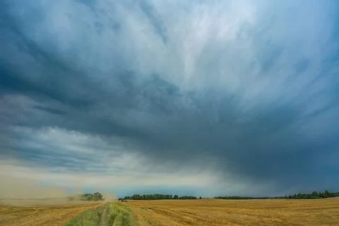 Outdoor work in the farmyard under a dramatic, cloudy sky Stock Photos