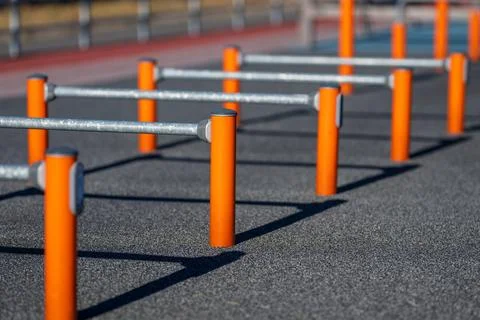 Outdoor workout area with parallel bars and shadows. 스톡 사진