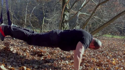 Outdoor workout  man. Stretching exercise using trx straps Stock Footage 166447233