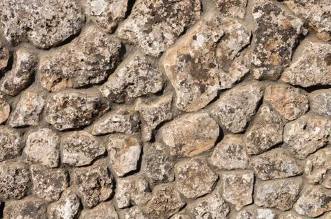 The outer facade of the building is made of natural stone of various shapes Stock Photos