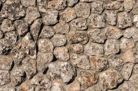 The outer facade of the building is made of natural stone of various shapes Stock Photos