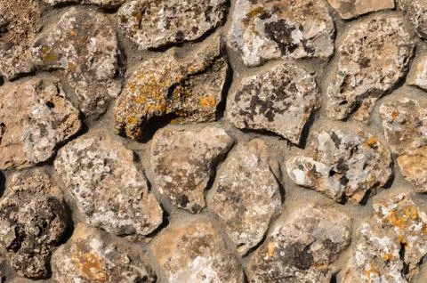 The outer facade of the building is made of natural stone of various shapes Stock Photos