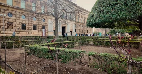 Outer gardens in front of the side facade of the Palace of Charles V in the Video stock 310073541