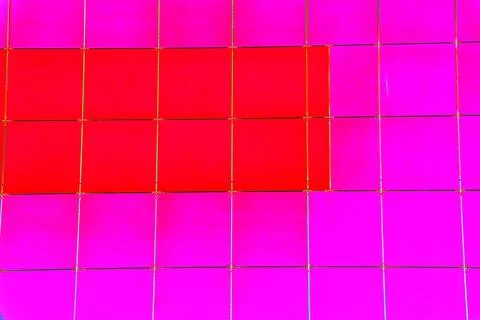 The outer wall of the building is finished with framed plastic tiles, the c.. Ilustración de archivo