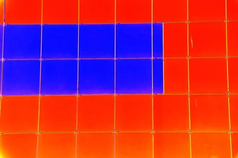 The outer wall of the building is finished with framed plastic tiles, the c.. Ilustración de archivo