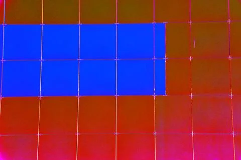 The outer wall of the building is finished with framed plastic tiles, the c.. Ilustración de archivo