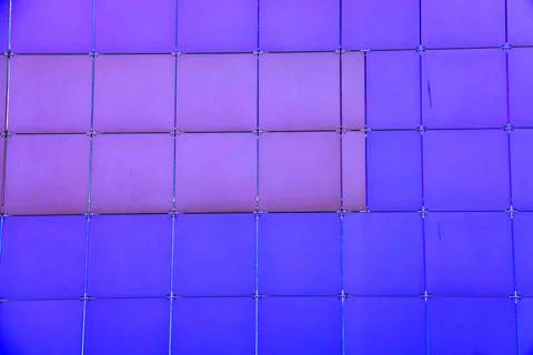 The outer wall of the building is finished with framed plastic tiles, the c.. Ilustración de archivo