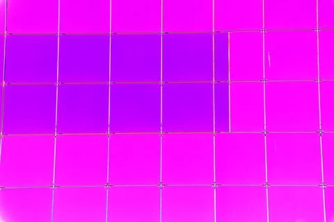 The outer wall of the building is finished with framed plastic tiles, the c.. Ilustración de archivo